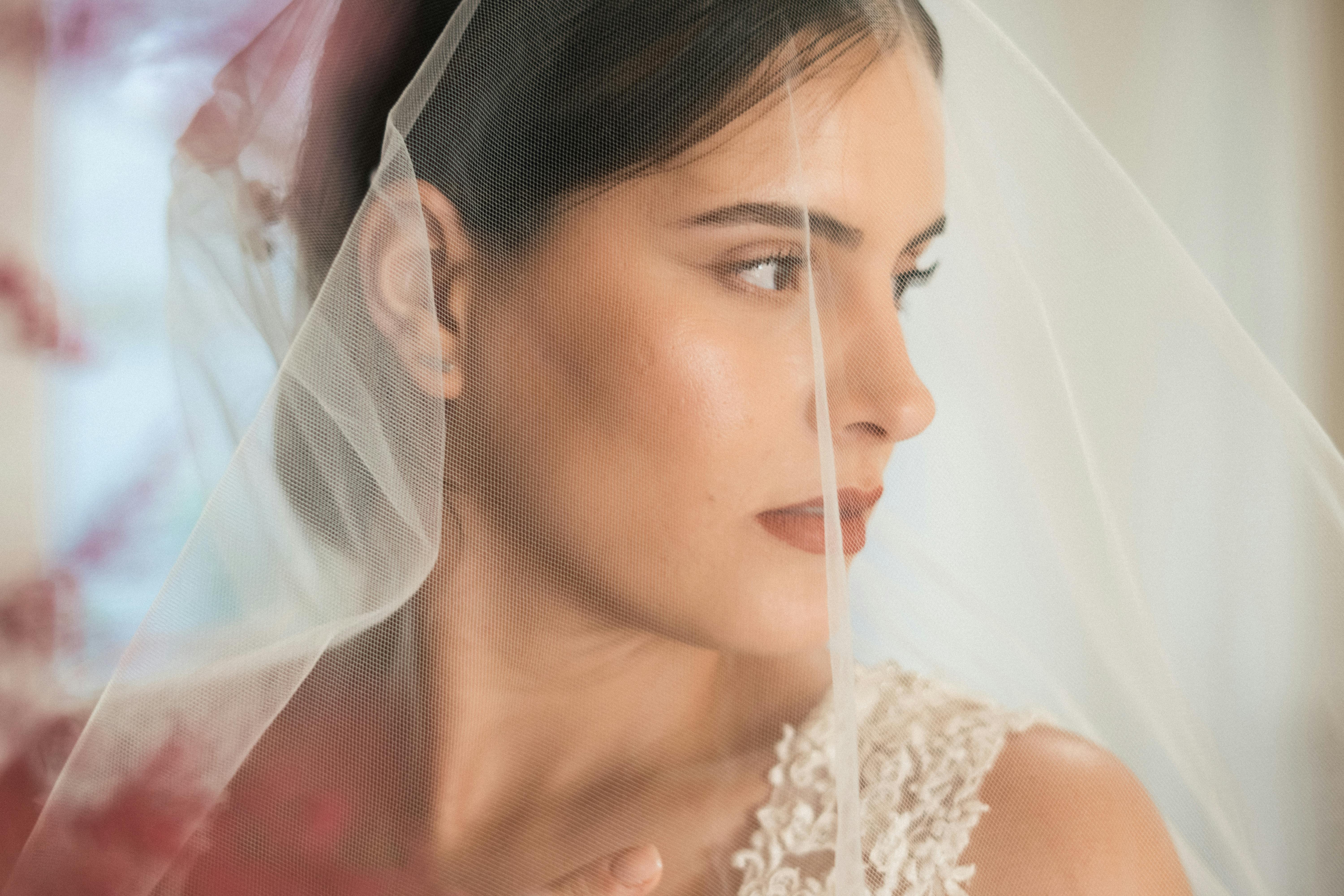 A serene bridal portrait capturing an elegant bride behind a veil.