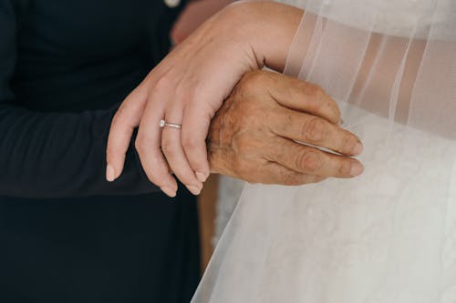 Free A Person Holding a Woman's Hand and Veil Stock Photo