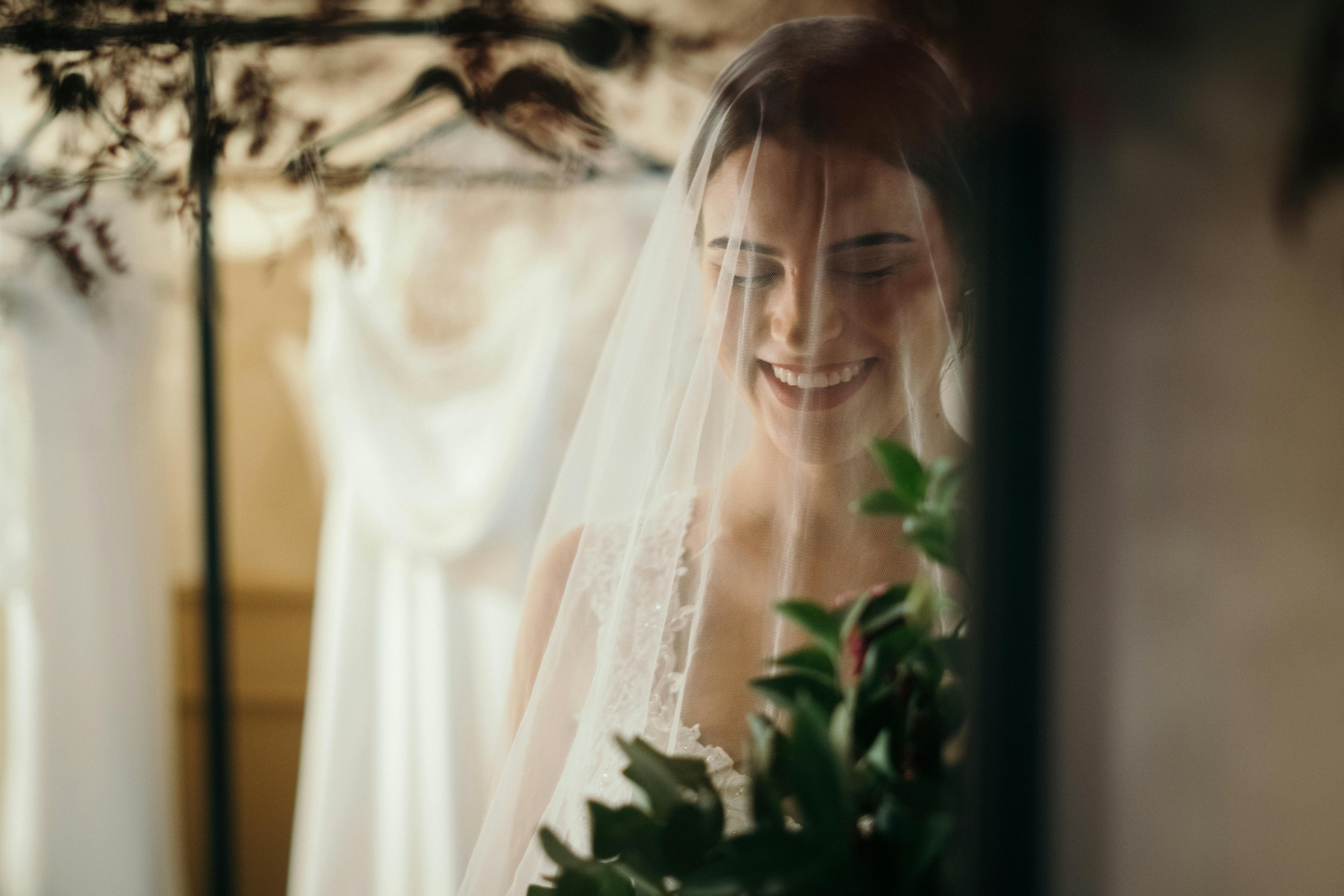 Free Woman in White Wedding Dress Holding Bouquet of Flowers Stock Photo