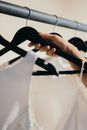 Close-Up Photo of a Person Holding a Black Hanger