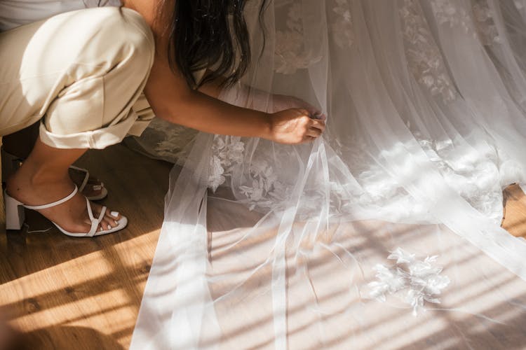 Bridesmaid Fixing The Brides Dress 