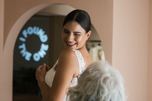 A Woman in White Lace Dress Smiling