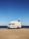 A White Van with a Radar Near the Sea