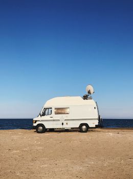 A White Van with a Radar Near the Sea