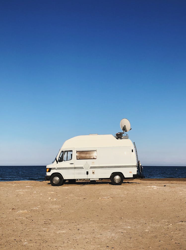 A White Van With A Radar Near The Sea