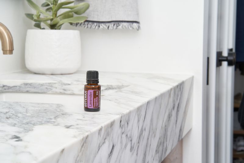 Small amber bottle of lavender essential oil on a clean surface