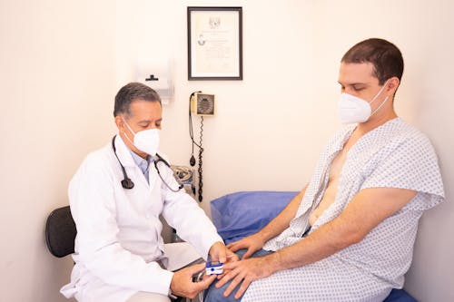 Doctor and Patient Sitting in an Examination Room 