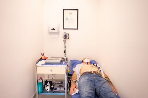 A Man Lying on Bed while Having an ECG