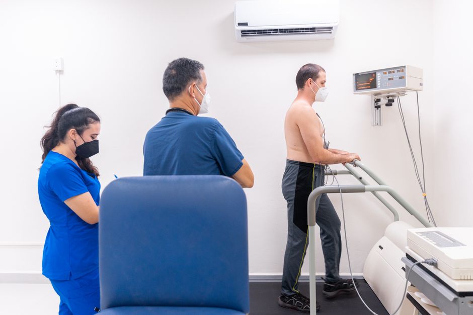Cardiologist examining a patient during a cardiac stress test — EKG and cardiovascular screening before ibogaine ceremony is mandatory, not optional