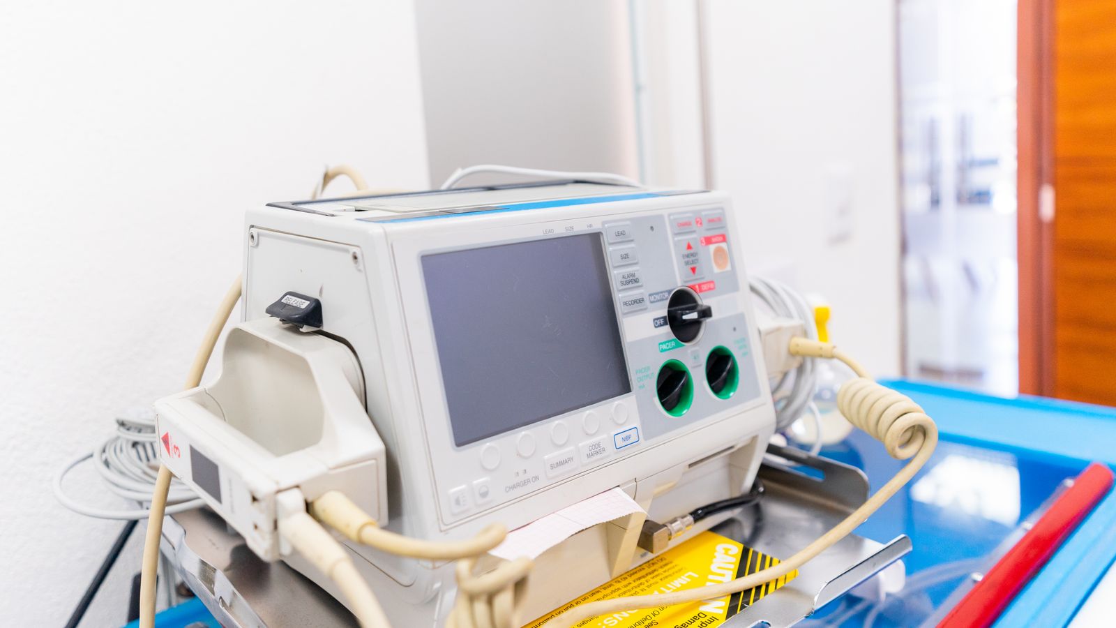 High-resolution image of a modern defibrillator in a hospital environment.