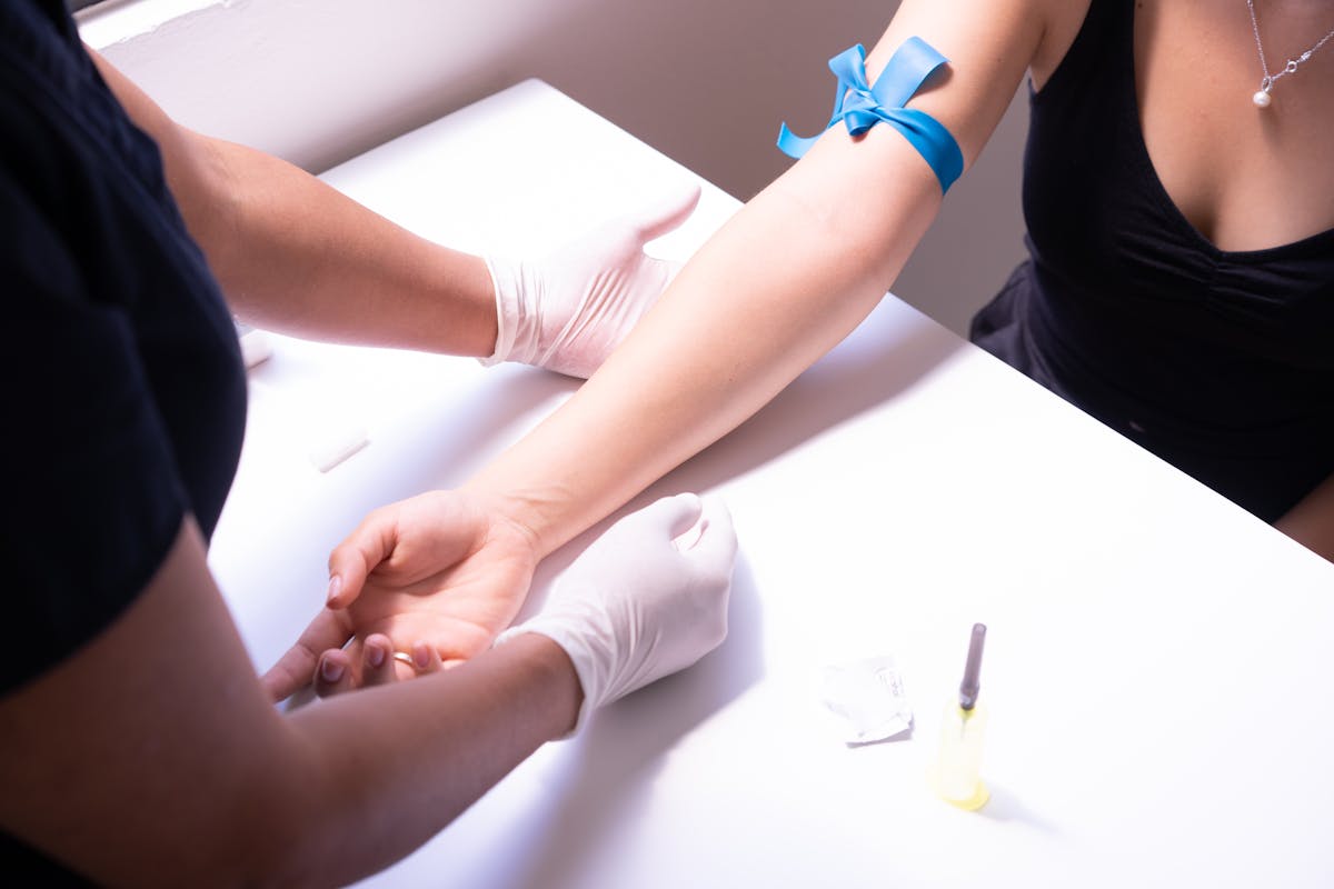 Healthcare professional preparing a patient's arm for blood draw