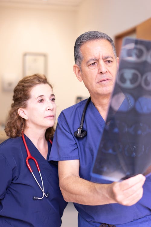 Free Man and a Woman Looking at an X-ray Stock Photo