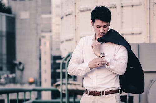 A Man Carrying a Suit on his Shoulder