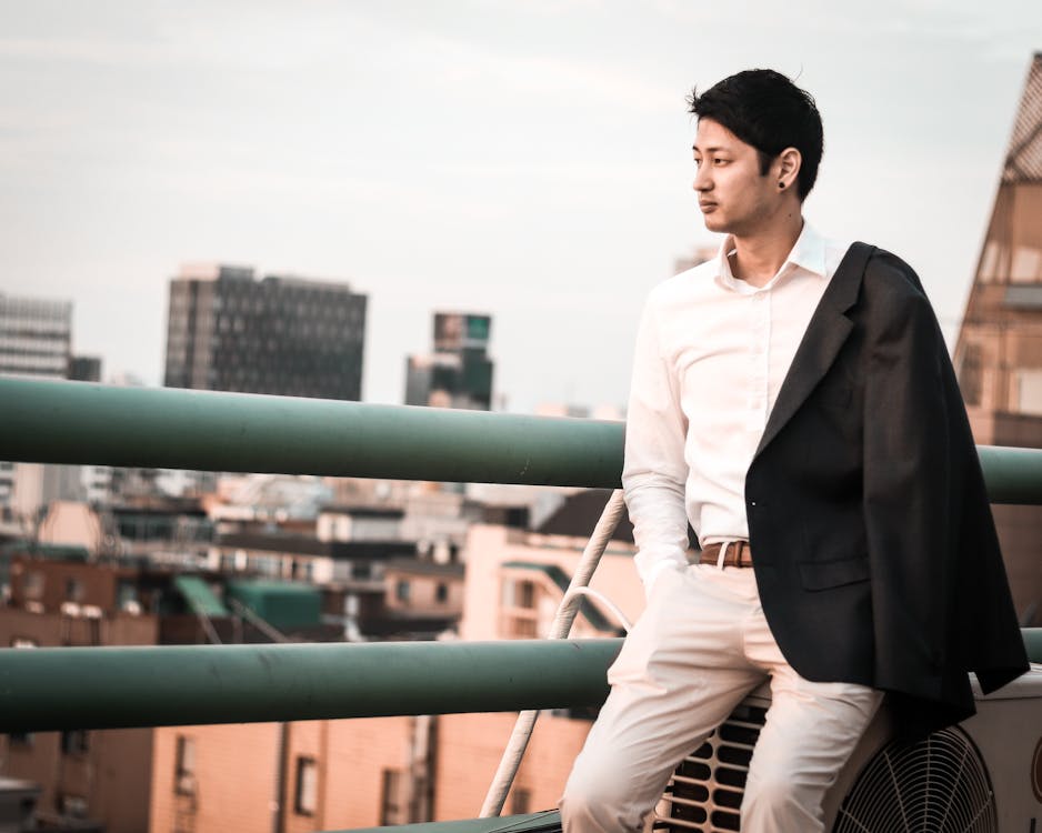 Man Sitting at a Roof Top