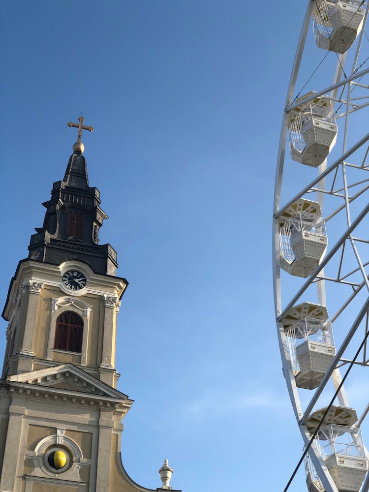 Ancient Church And Wheel Against Blue Sky