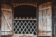 Brown Wooden Door With Black Metal Gate
