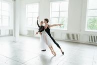 Woman in White Dress Dancing on White Floor Tiles