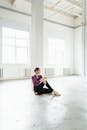 Woman in Black Pants Sitting on Floor