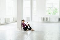 Woman in Black Dress Sitting on Floor