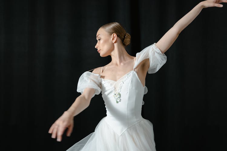 A Ballerina In White Tutu Dress Dancing