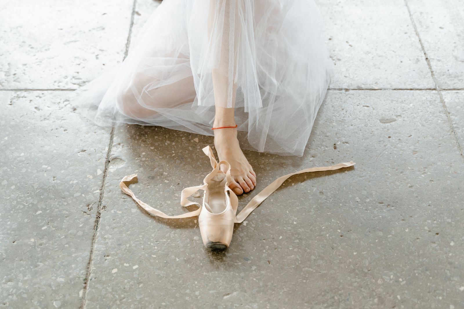 Runner tying a shoe before choosing an ankle brace size