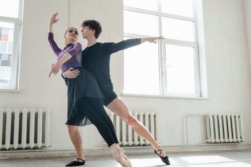 Dance couple practising a lift in the studio