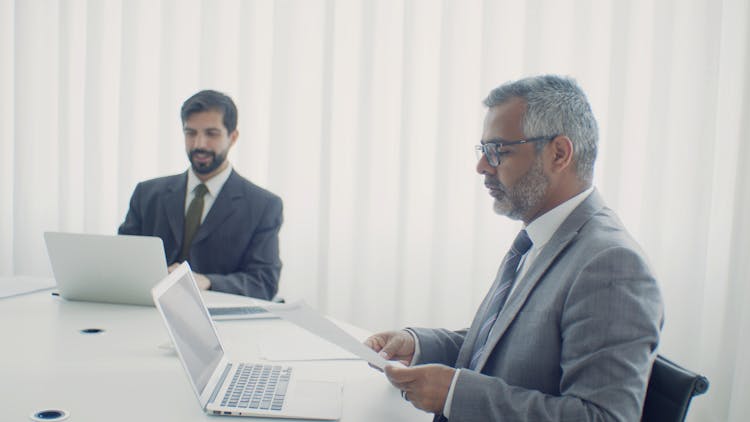 Man In A Suit Reading A Document