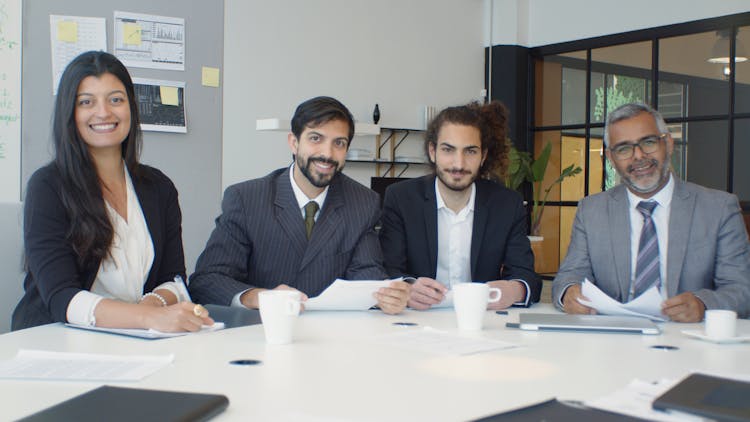 Office Team Sitting At The Table