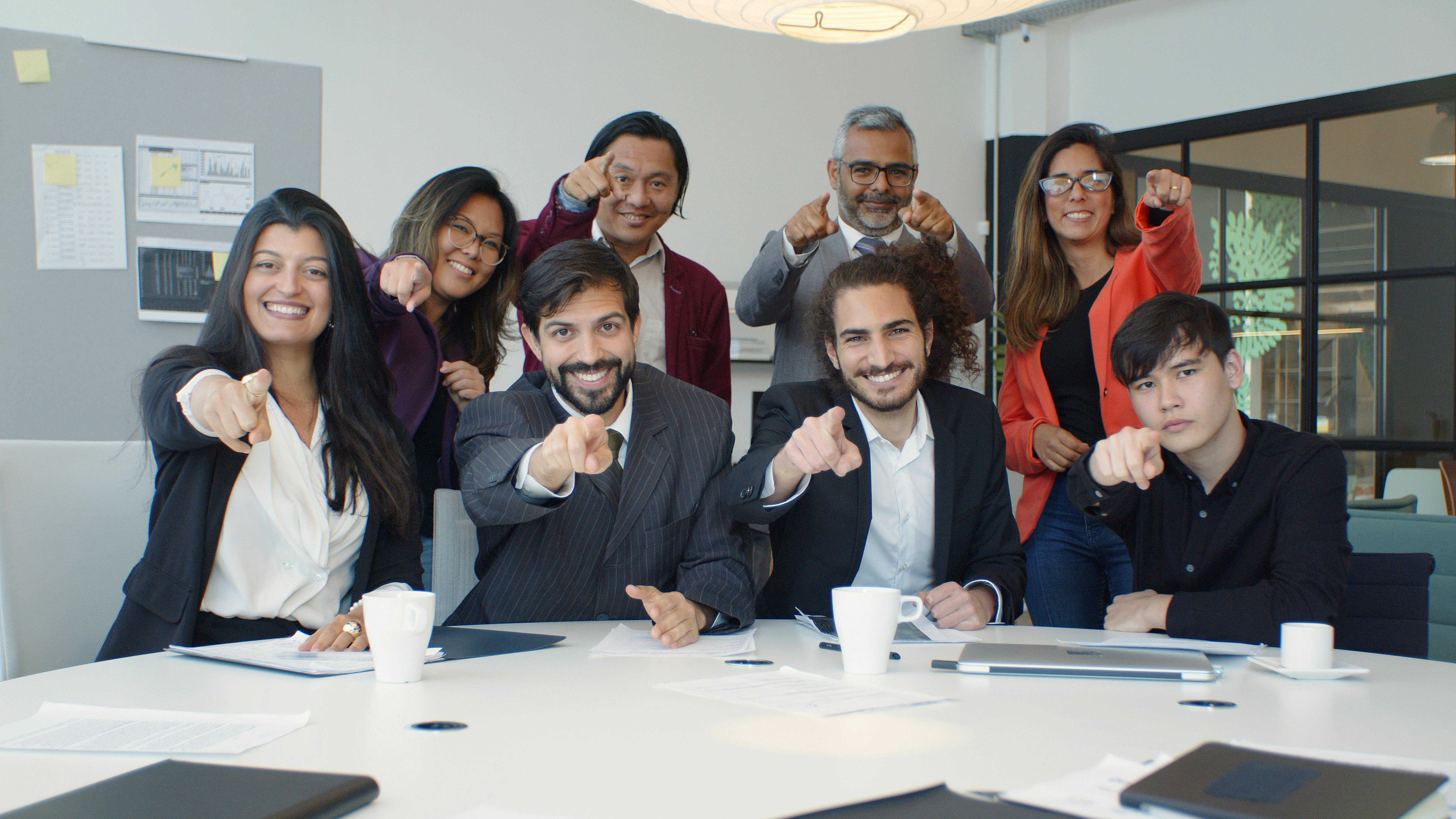 group of people pointing with their fingers