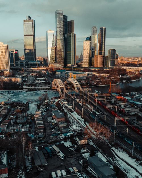Free Aerial shot of Moscow city skyline with skyscrapers, bridges, and snowy landscape in winter. Stock Photo