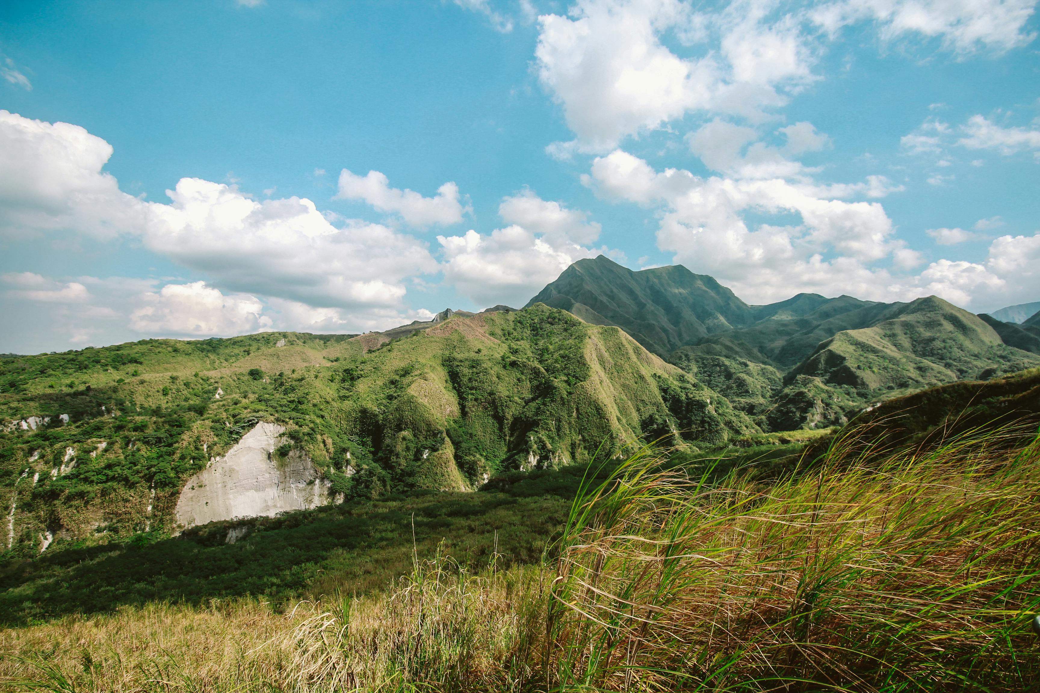 photo of mountains covered with grass