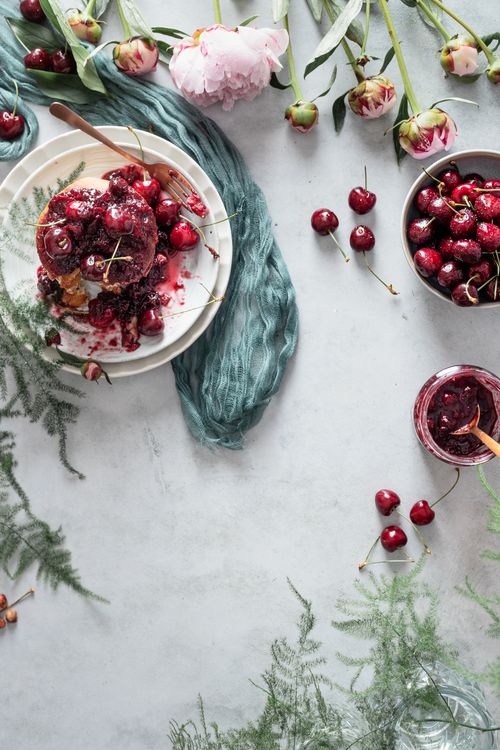 Free Delicious cherry pancakes with fruit and peonies for a refreshing brunch. Stock Photo