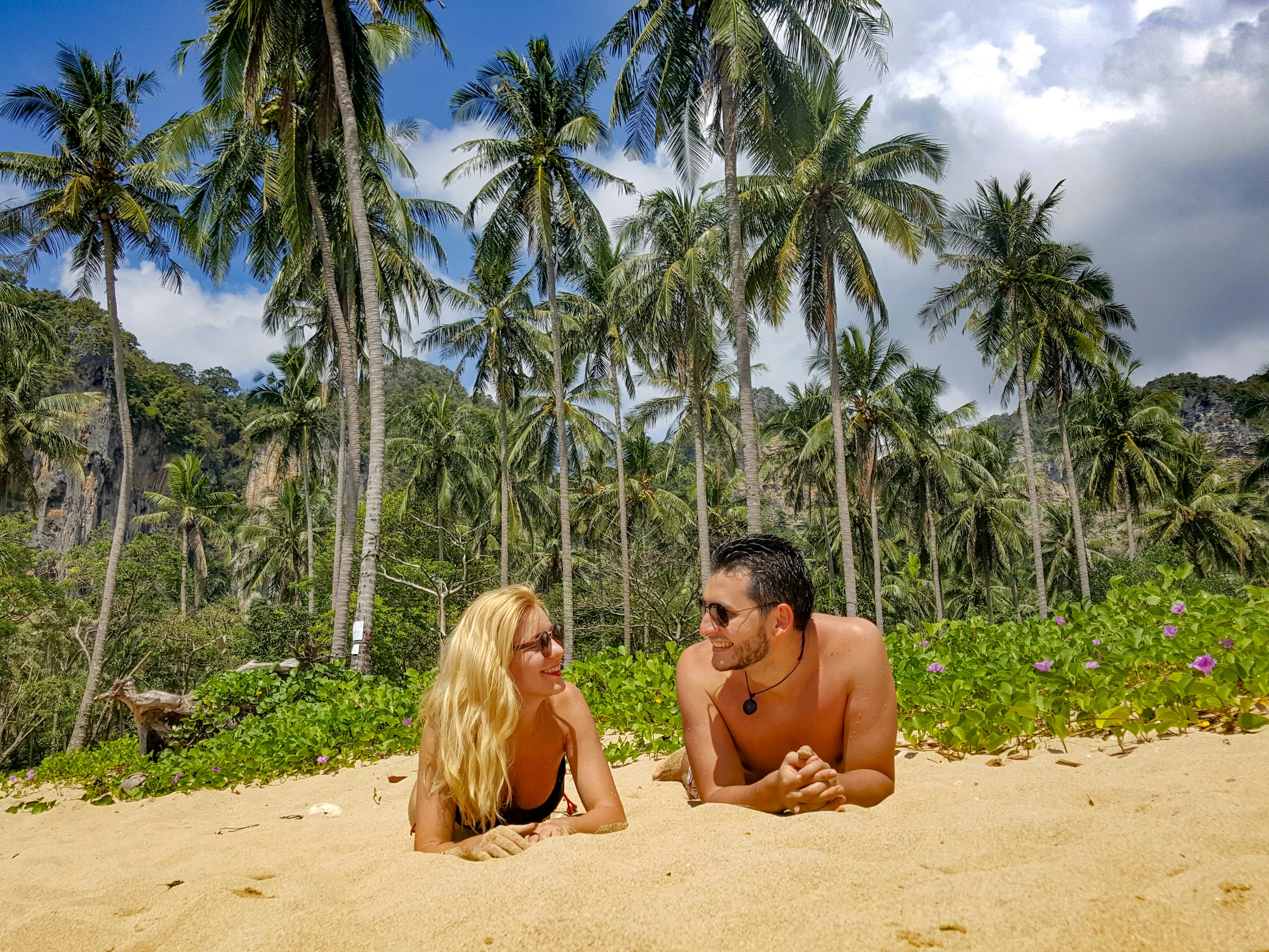 Free Man and Woman Lying on Sand Stock Photo