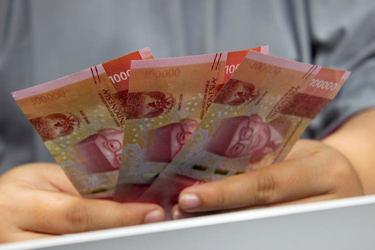 A Person Holding Indonesian Money