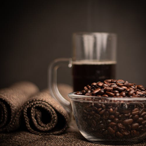 Free Close-up of Coffee Beans and Coffee on Table Stock Photo