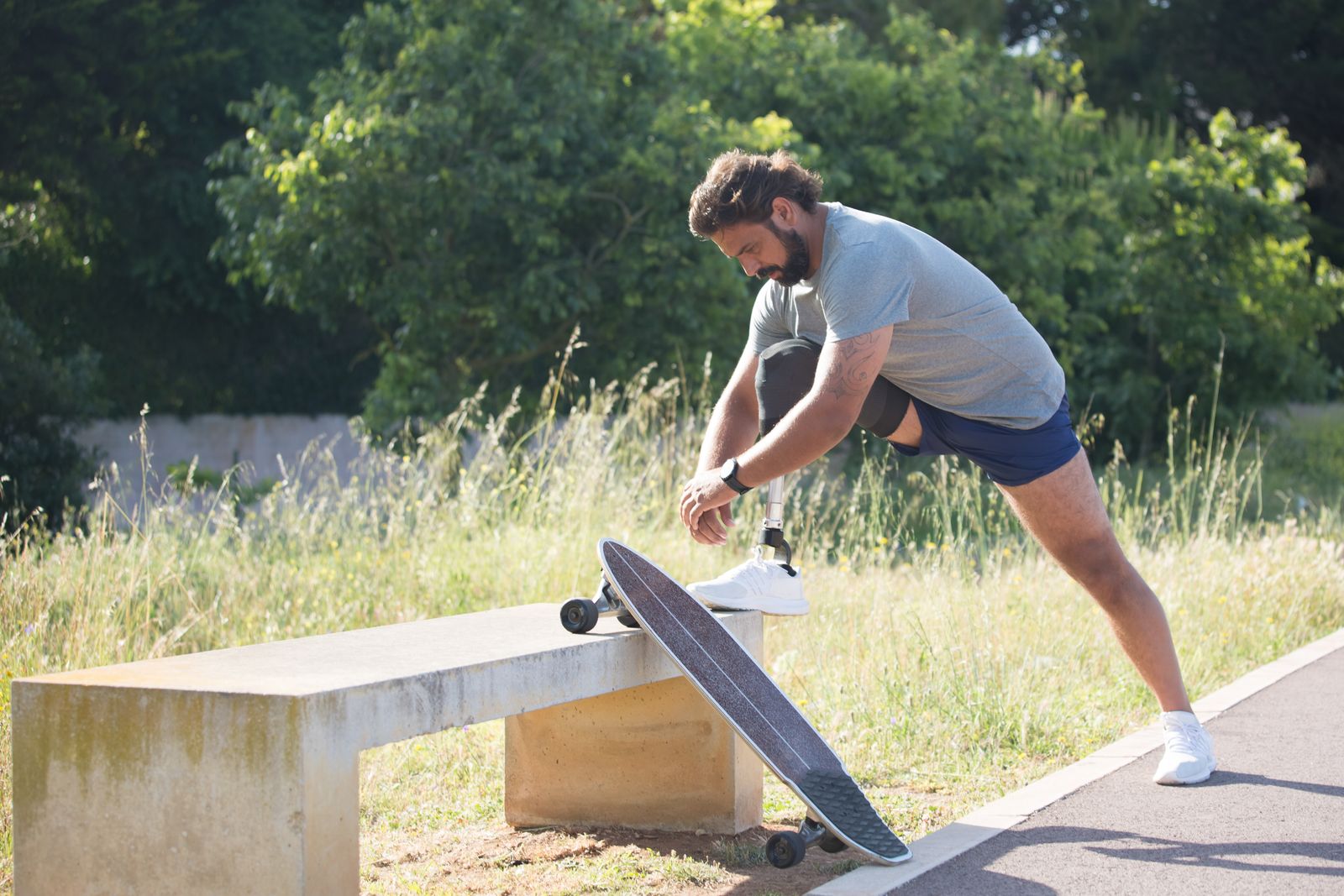 Runner adjusting a knee brace outdoors before activity