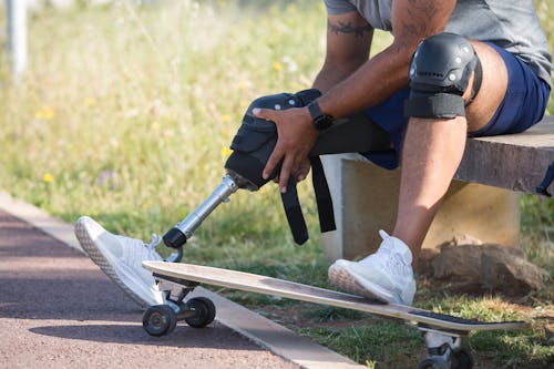 Free Close Up Photo of Man Stepping on a Skateboard Stock Photo
