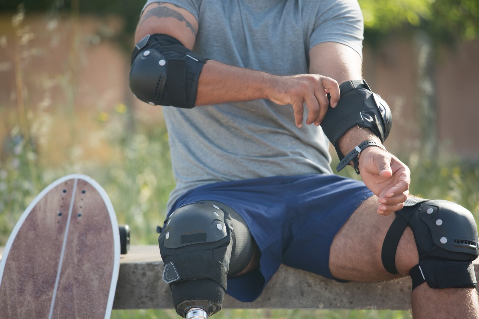 Runner adjusting a knee brace outdoors before activity
