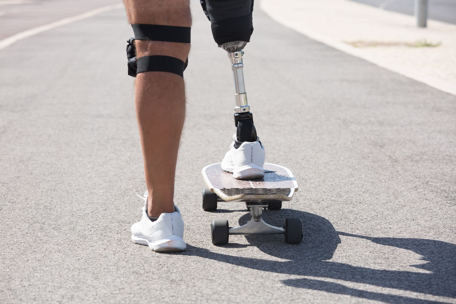 Athlete warming up outdoors with knee support focus