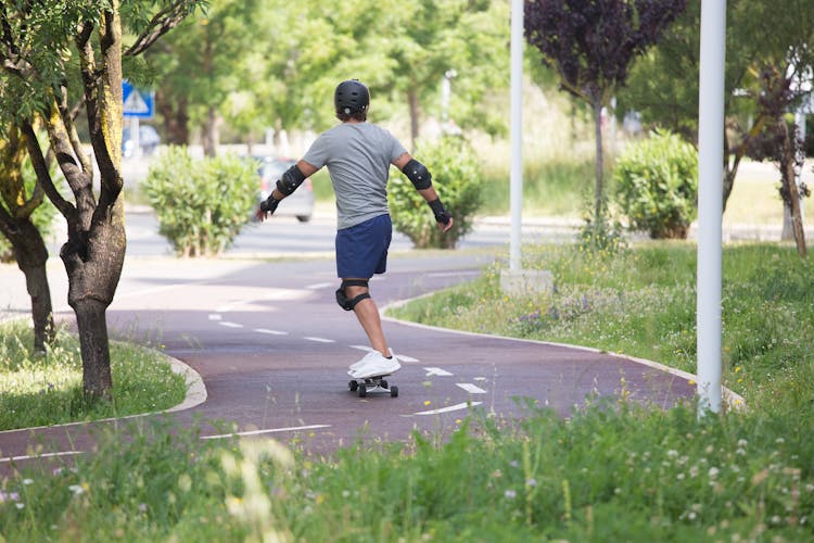 A Man With Black Helmet Skateboarding