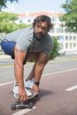 Man in Gray T-shirt and Blue Shorts Doing Push Up on Road