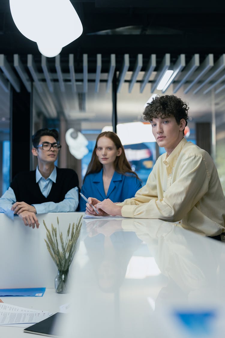 Elegant Young People Posing At An Office Desk