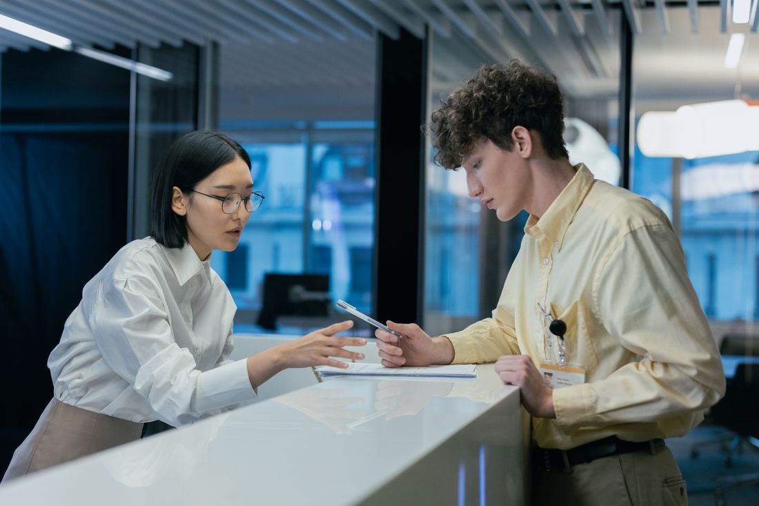 Two professionals discussing at a modern reception
