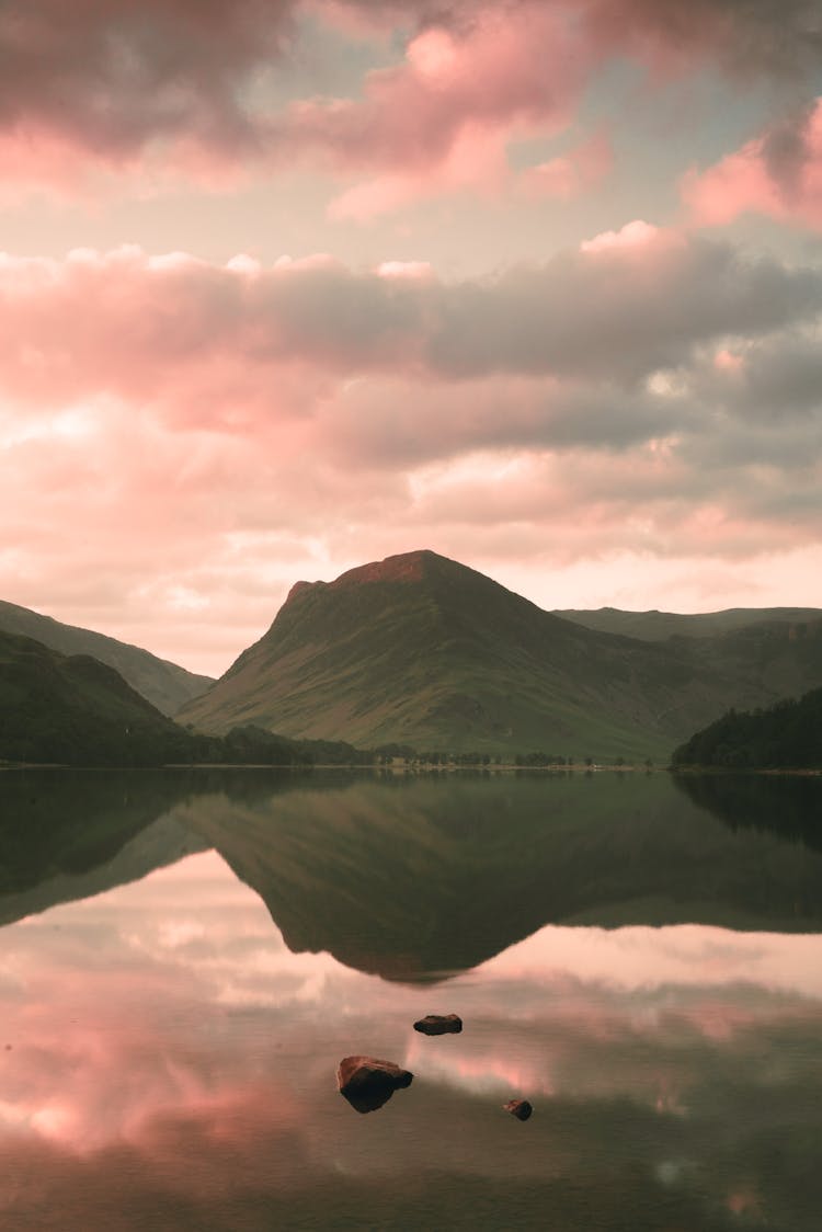 Mountain Reflecting In A Still Lake At Sunset