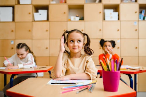 Free Girl Sitting at her Desk at her School Stock Photo