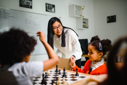 Free Woman and Children in a Chess School Stock Photo