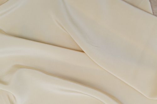 Free Close-up of smooth cream silk fabric texture, showcasing its softness and elegance. Stock Photo