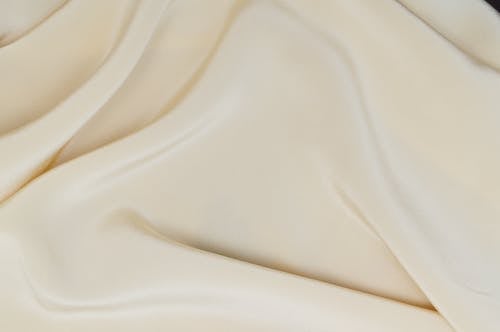 Close-Up Photo of a Smooth Cream Textile