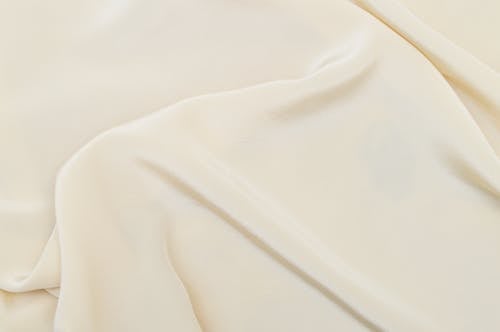 Close-Up Photo of a Smooth Cream Textile