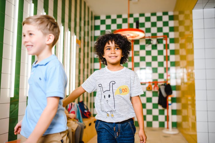 Boys Walking Inside A Room Smiling 